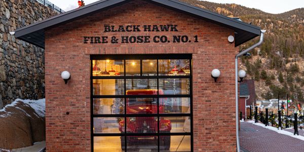 Historic firehouse with a vintage fire truck inside.