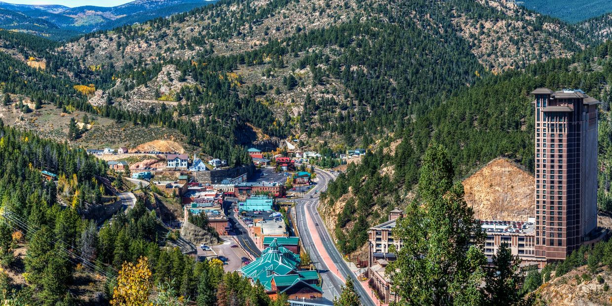 A small town nestled in a mountainous forest valley.