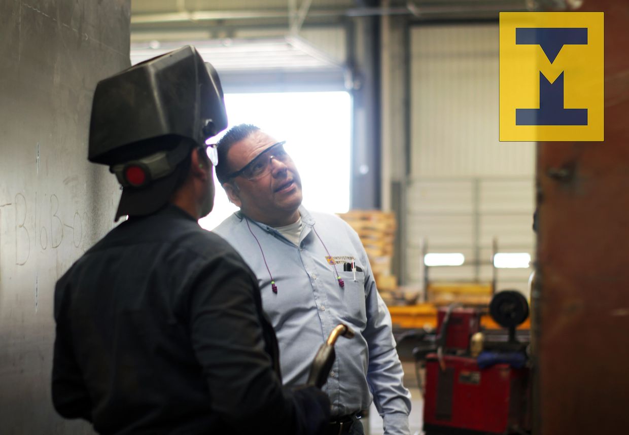 engineer performing a quality assurance check on a contract metal fabrication