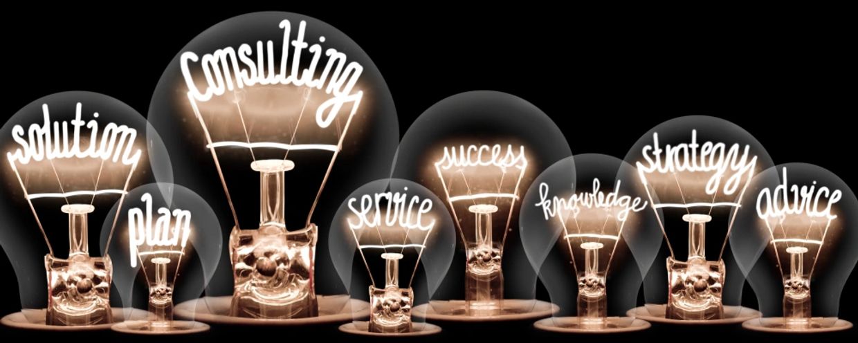Photo of light bulbs with shining fibers in a shape of CONSULTING concept