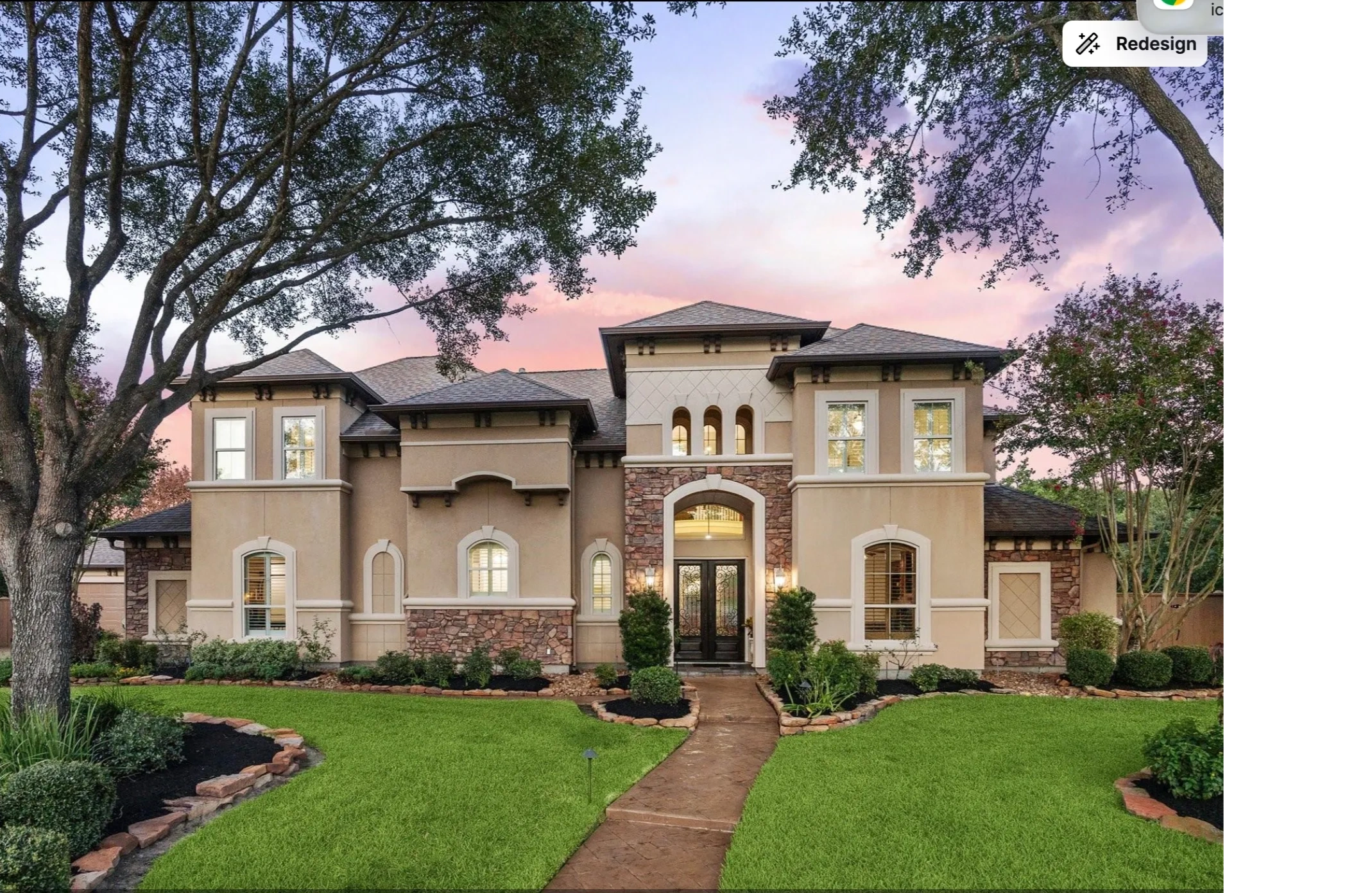 Elegant two-story house with stone accents and lush front yard.