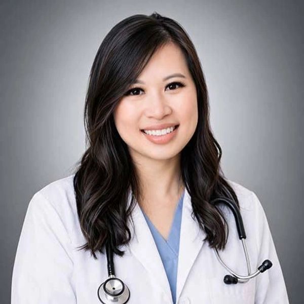 Young female doctor smiling with stethoscope.