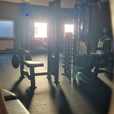 Empty gym with sunlight streaming in.