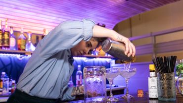 bartender making a drink inside mobile bar 