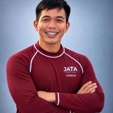 Smiling sports coach in a maroon shirt with braces.