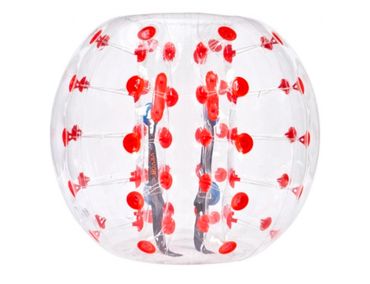 Two people inside a transparent inflatable bubble with red spots.