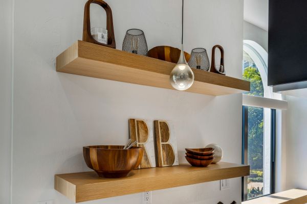 Wooden shelves with decorative bowls and geometric pieces.