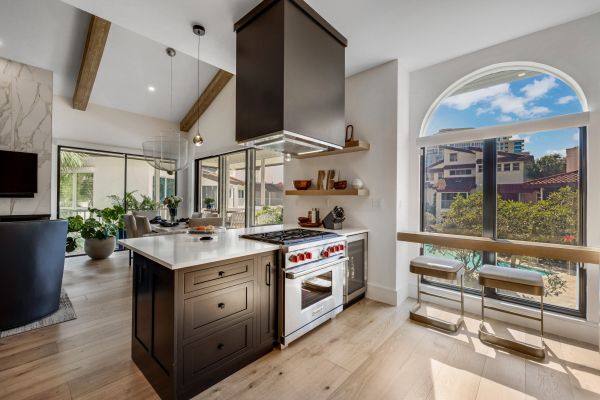 Modern kitchen with island and large window seating.