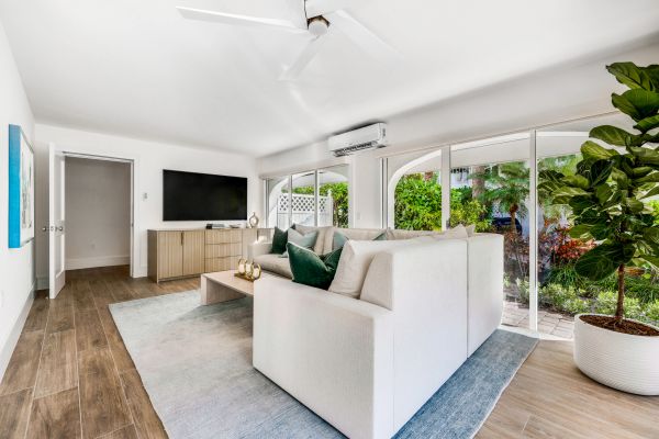 Bright living room with white sofa and large windows.