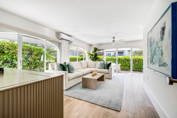 Bright and airy living room with large windows and light decor.