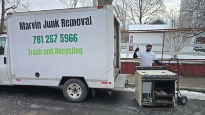 Marvin Junk Removal standing next to truck with a removed appliance in Cambridge, MA