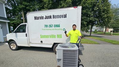Marvin Junk Removal truck loaded with scrap metal on a Boston MA job site near the South End