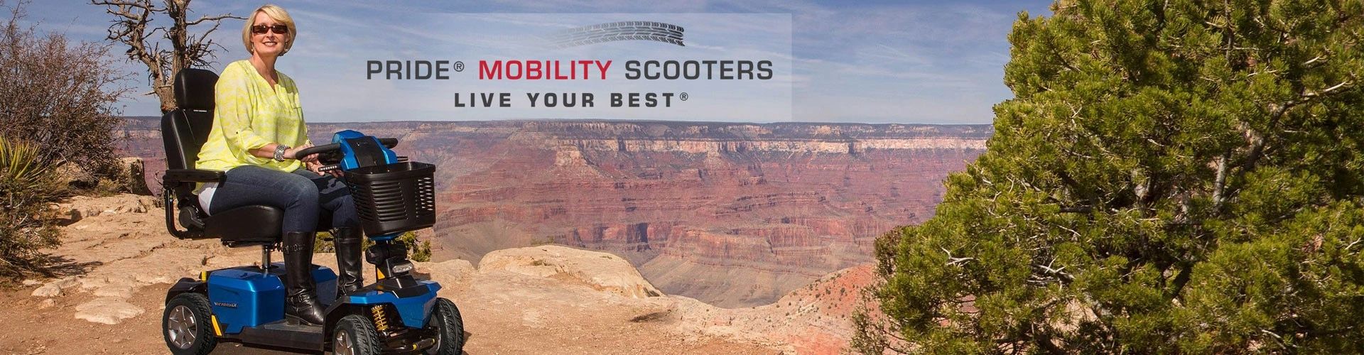 Woman enjoying scenic Grand Canyon ride on a blue mobility scooter.