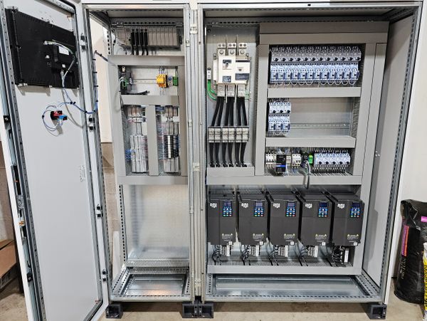 Open industrial electrical control panel showing wiring and components.