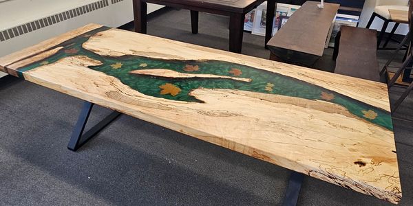 Wood and resin river dining table with flower insets.