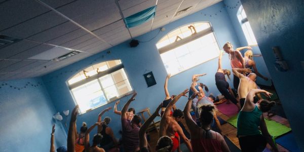 Group yoga session in blue room.