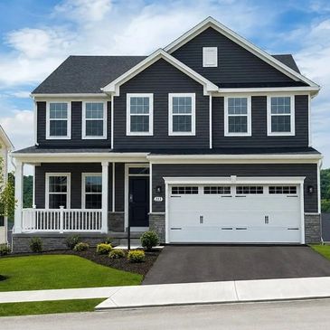 Modern two-story house with black siding and white trim.
