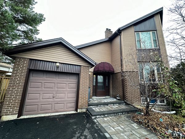 Khaki vinyl siding complemented with Espresso brown aluminum downpipe, soffit, fascia