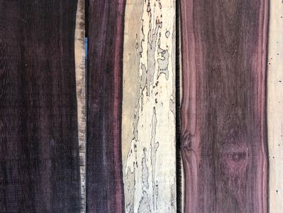Close-up of various wooden planks with different colors and textures.