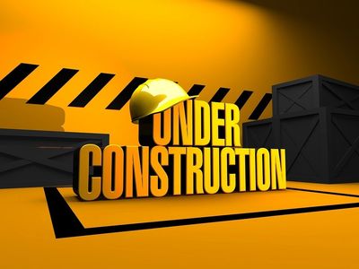3D 'Under Construction' text with a yellow hard hat and black crates on an orange background.