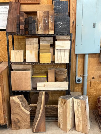 Wood blocks of various shapes and sizes neatly arranged on shelves in a workshop.