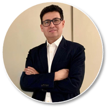 Man in a black blazer and glasses posing confidently with arms crossed.