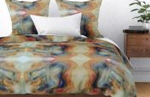bed duvet and pillow coverings in shades of blue, tan, orange created by artist Chillon Leach