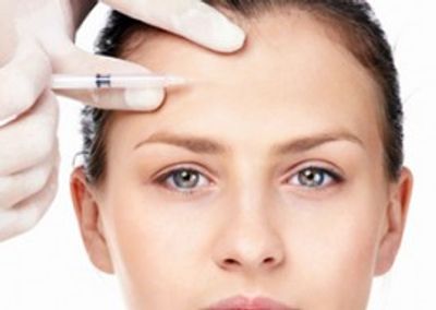 Botox cosmetic being injected into forehead