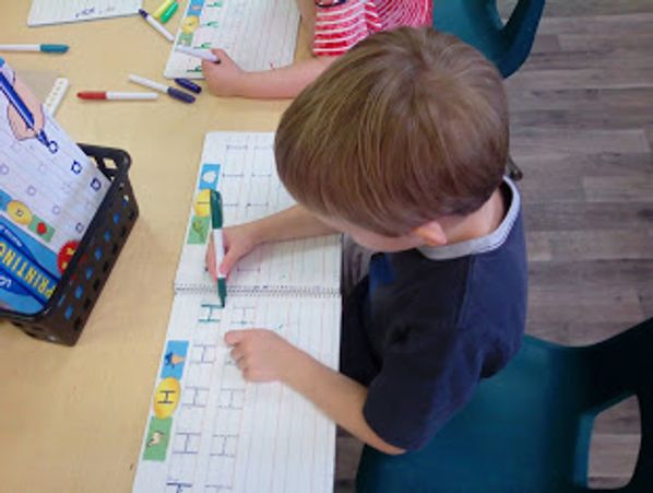 Pre-k child writing the letter h