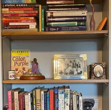 A bookshelf with many books and a clock