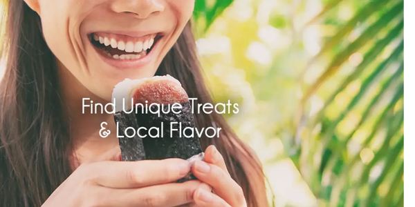 Woman smiling while holding a unique local treat wrapped in seaweed.