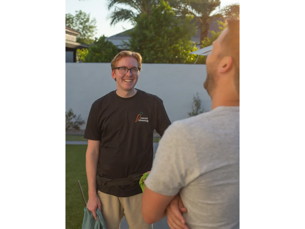small professional window cleaning business owner chatting with happy customer, both are laughing