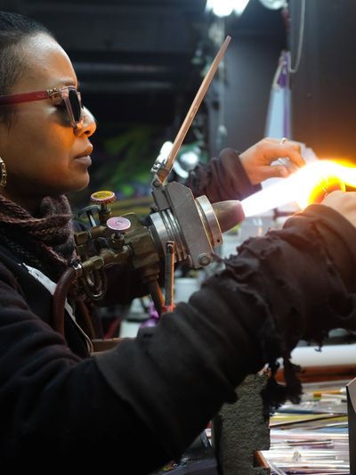 Picture of Kim Thomas creating glass art