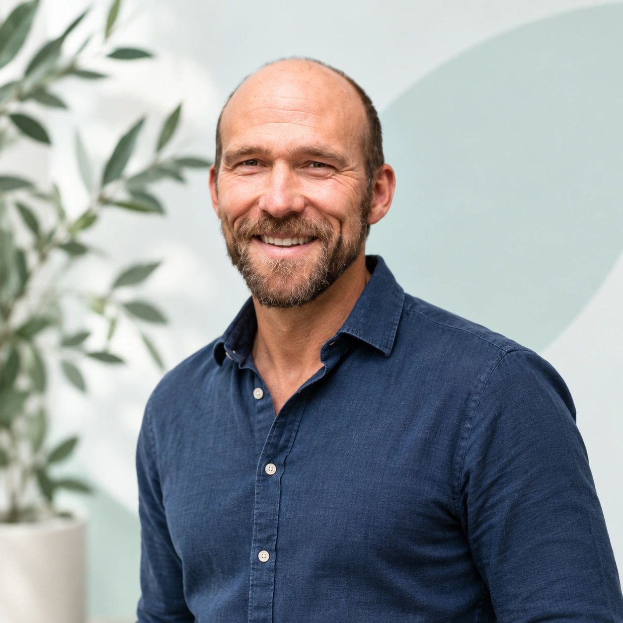 Smiling man in a blue shirt.
