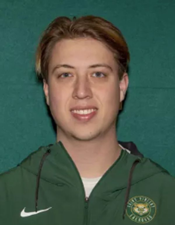 Young man in green jacket with logo and Nike symbol.
