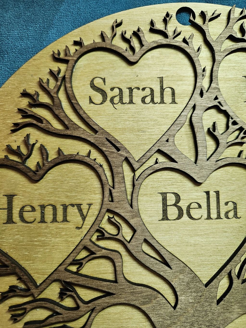 The use of wood as the base material for this family tree adds a touch of warmth and natural beauty 