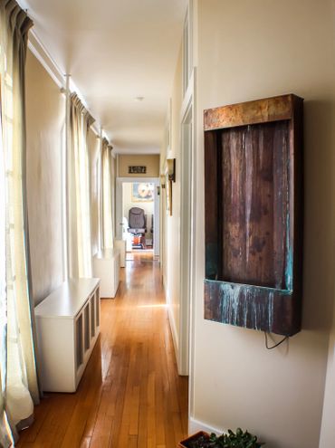 Hallway with water feature and chair