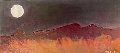 A full moon shines over a mountain range with fiery orange foreground.