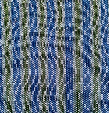 Textured fabric with blue, green, and white wavy stripes and dot patterns.
