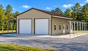 Metal building with two garage doors and side awnings.