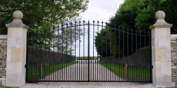 photos of a gated driveway with clam shell surface