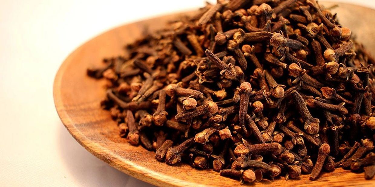 Whole Cloves harvested on a wooden plate - Brazspice Spices cloves