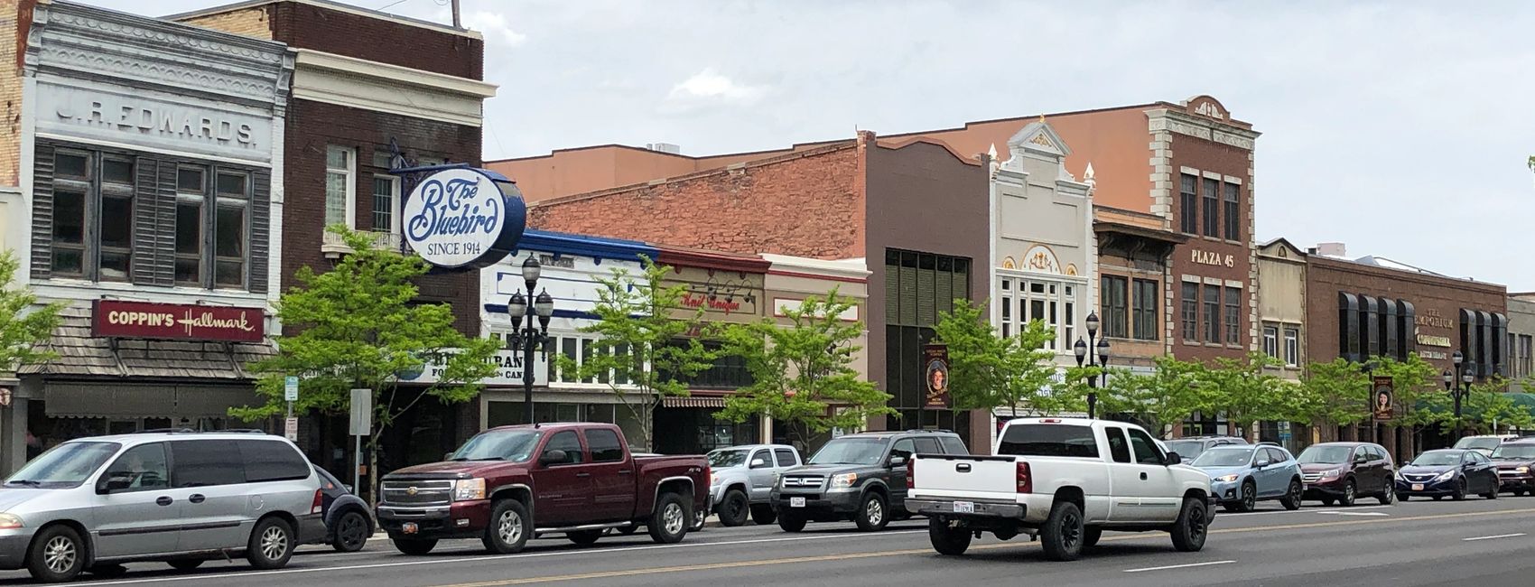 Street view of a town with cars and stores