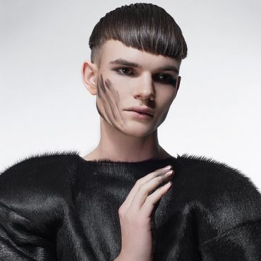 Young person with unique hairstyle and face paint.