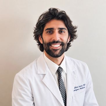 Smiling male doctor in white coat and tie.