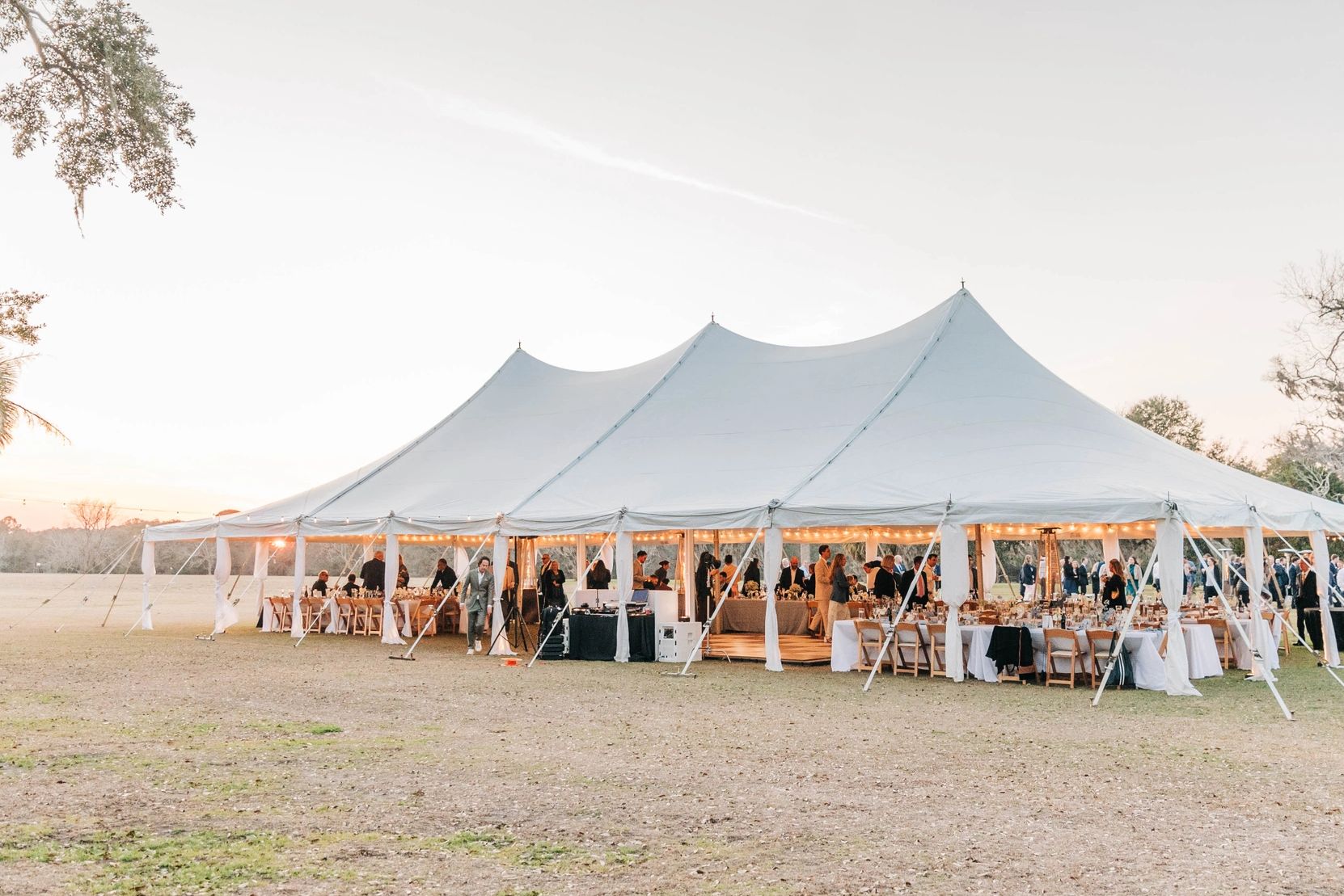 Elegant Sunset Wedding Reception Under White Pole Tent