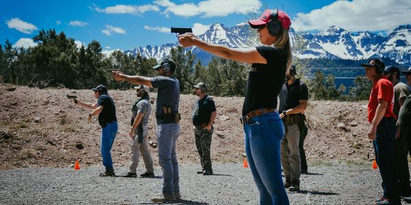 student shooting pistol in firearms class