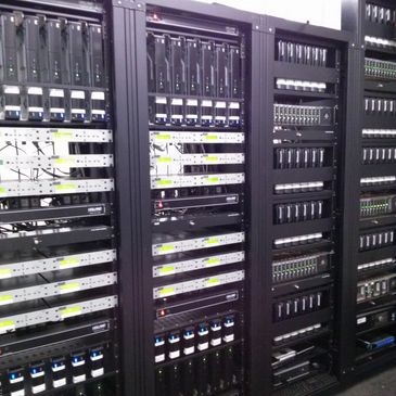 Rows of server racks filled with networking equipment and cables.