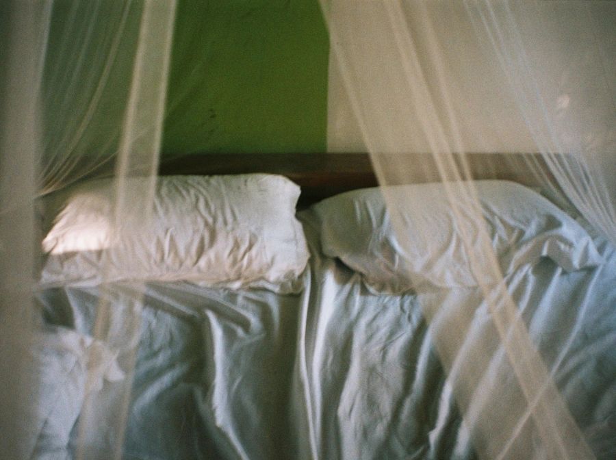 A bed under netting by photographer and photography instructor Flóra Cabassut-Zsemlye.