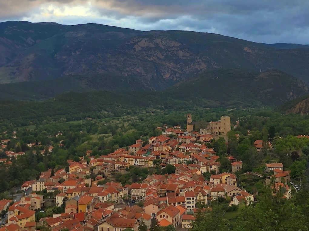 A view of Vernet les Bains showing the villages bright red roof tops and St Saturnin Church.